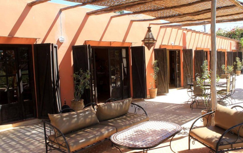 Location de vacances - Chambre d'hôtes à Agadir - coin detente et , plus loin, table pour les petits dejeuners