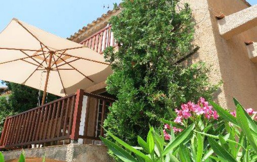 Location de vacances - Mas à Agay - Vue de la terrasse avec parasol depuis le jardin