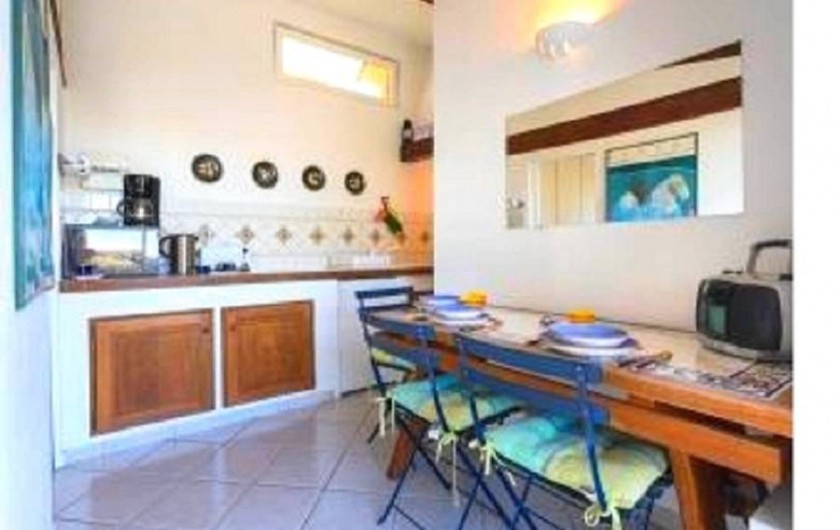 Location de vacances - Studio à Cagnes-sur-Mer - Vue cuisine américaine equipée avec la table à manger du studio Francy