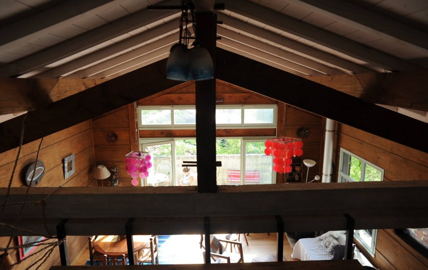 Location de vacances - Chalet à Le Cap Ferret - Vue de la salle de séjour depuis la mezzanine .