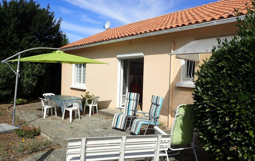 Location de vacances - Villa à Saint-Hilaire-de-Riez - terrasse côté jardin avec son salon de jardin son parasol et ses transats