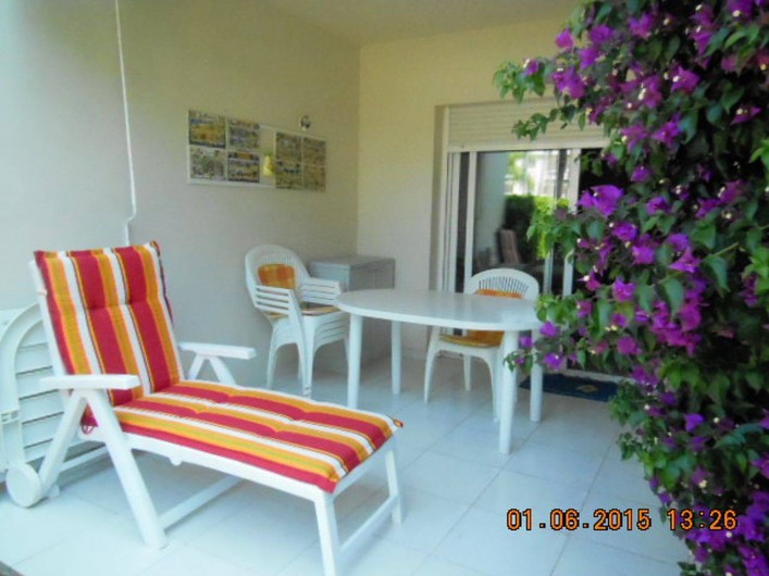 Location de vacances - Appartement à Dénia - la terrasse couverte agrémentée par le bougainvillier en fleurs