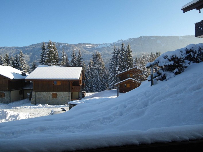 Location de vacances - Appartement à Les Carroz d'Arâches - vue de la terrasse sur chalet résidence