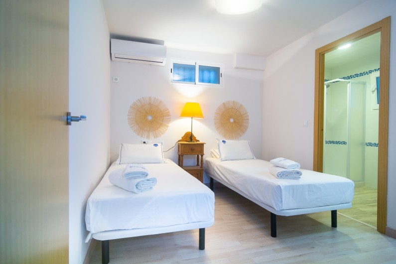 Location de vacances - Chalet à Marbella - Deux lits simples, une table de nuit avec lampe, de grandes armoires en bois