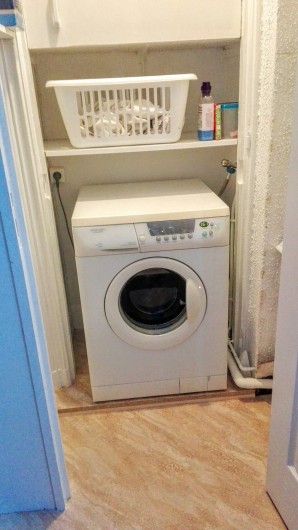 Location de vacances - Appartement à Le Mont-Dore - Pièce avec machine à laver, table et fer à repasser, aspirateur, etc...